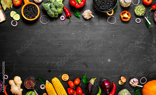 Frame of organic food. Fresh raw vegetables with black beans.
