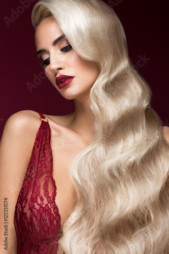 Poster Beautiful blonde in a Hollywood manner with curls, red lips, red lingerie