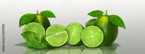 Sliced and whole limes in a panoramic