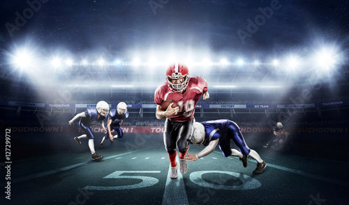 Lacobel American football players in action on stadium with ball