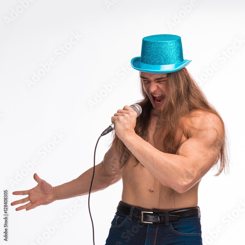 Poster singer bodybuilder shirtless with long hair in a blue hat with a microphone on a