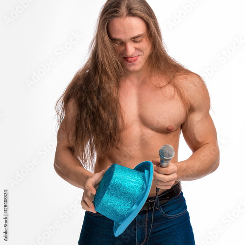 Poster singer bodybuilder shirtless with long hair in a blue hat with a microphone on a