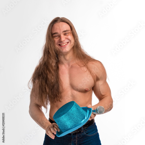 Poster singer bodybuilder shirtless with long hair in a blue hat with a microphone on a