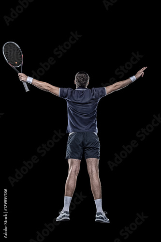 Obraz na plátně Tennis player with hands up isolated on black