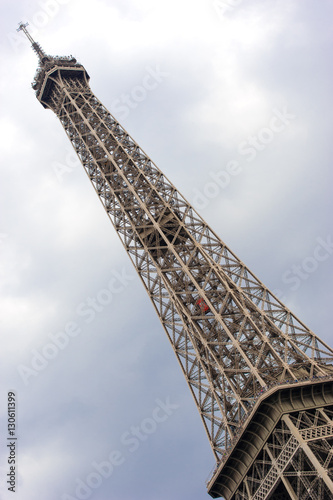 Poster Detail of the Eiffel Tower on the background of a cloudy stormy sky