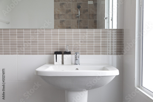  White sink and dispenser in bathroom