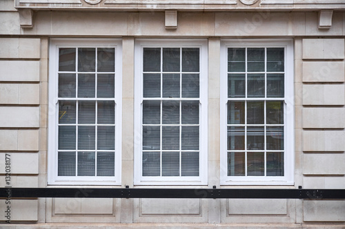 Window Section With Three Colonial Style Windows In Sand Colored Window Section With Three Colonial Style Windows In Sand Colored Ashlar Walling Building Facade