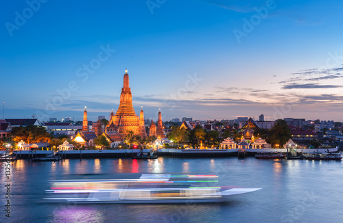 Poster The boat was sailing in Chao Phraya River, background Wat Arun at sunset time ,Bangkok, Thailand
