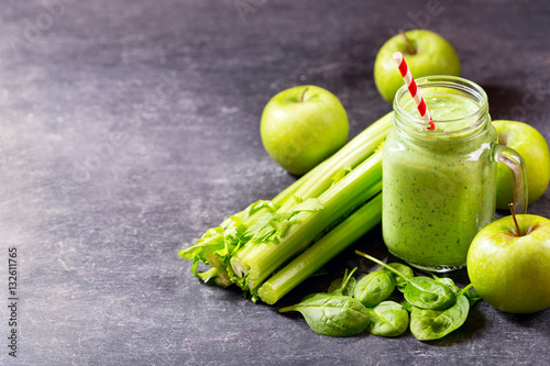 glass jar of green juice smoothie with spinach, apple and celery