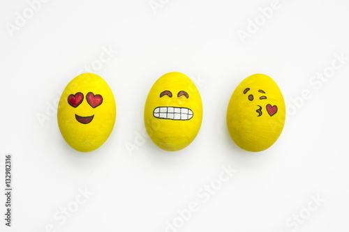 Poster Painted emoji easter eggs in different moods and facial expressions such as kissing, smiling or being in love, in isolated white background