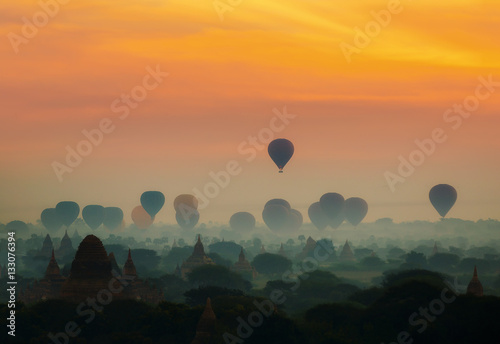 Poster cenic sunrise with many hot air balloons above Bagan in Myanmar