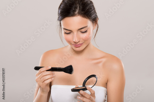 Woman applying make up
