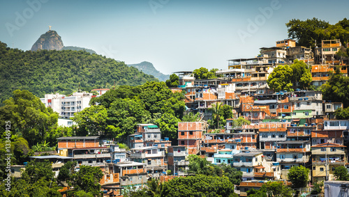 Obraz na płótnie Christ looking at Favela (Shanty Town) in Rio De Janeiro, Brazil