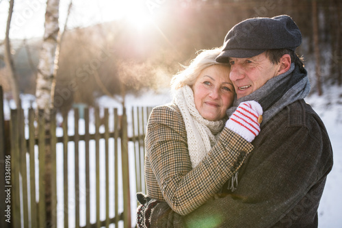Beautiful senior couple on a walk on sunny winter day