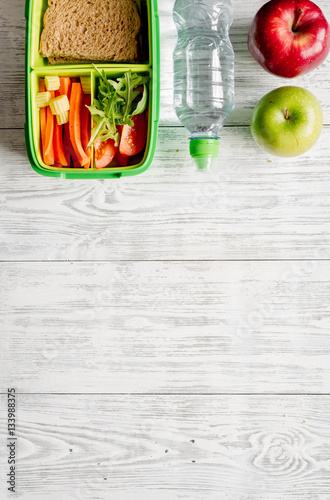 kid menu lunchbox for school top view on wooden background