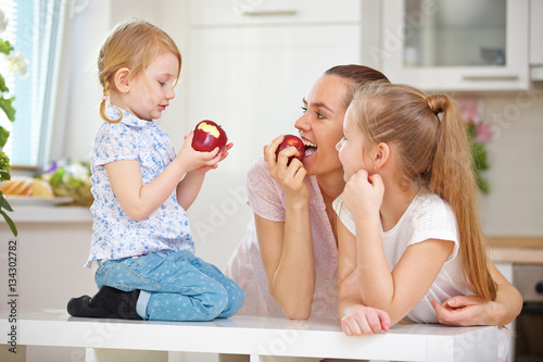 Mutter und Kinder essen Apfel zusammen