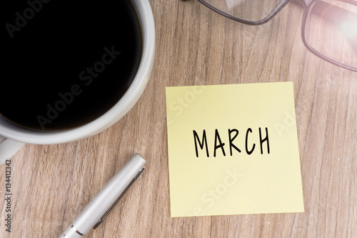 MARCH text on yellow note