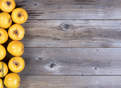 Freshly harvested golden apples on rustic wooden boards