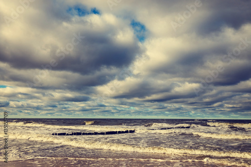 Sandy yellow beach with cloudy sky, Baltic Sea