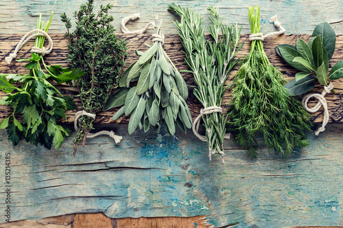 fresh herbs on wooden background with space for text © Sunny Forest