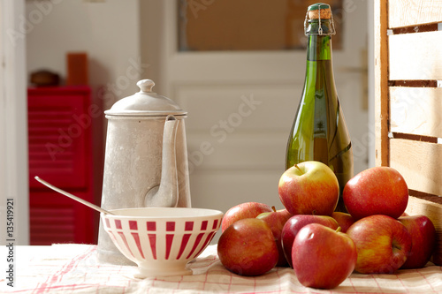 bottle of cider with fresh apples