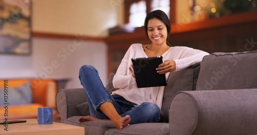 Young white girl browses the internet on her tablet