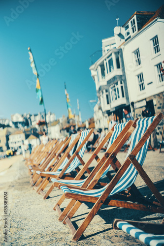 Poster Empty deck chairs along the St Ives beach in the harbour front.