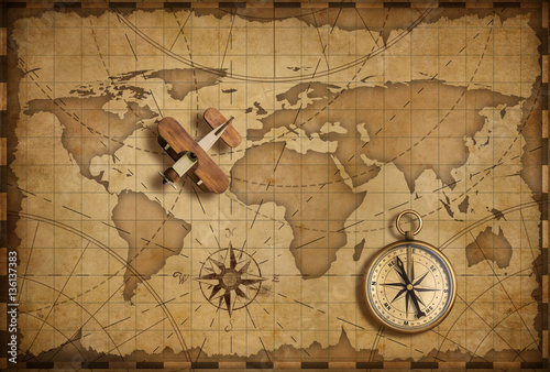 Obraz na płótnie Small wood airplane over world nautical map as travel and communication concept