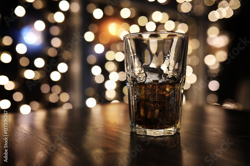 glass of alcohol with ice on blured background with circle bokeh Poster