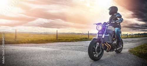 motorbike on the road riding. having fun riding the empty road on a motorcycle tour / journey