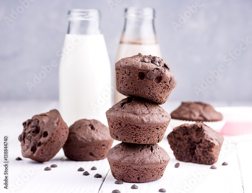 Poster Chocolate muffin with two bottle of milk Chocolate milk Wooden background