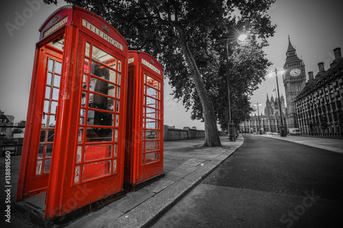  Traditional red phone booth in London with the Big Ben in the background