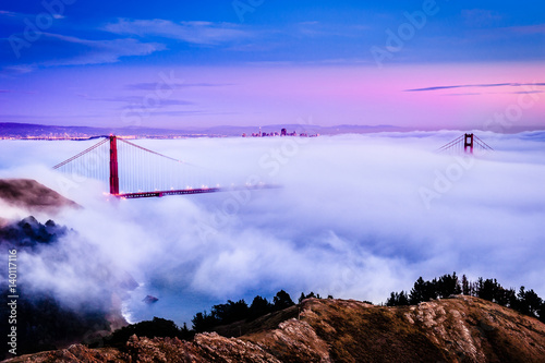 Poster Golden Gate Bridge at dawn surrounded by fog from Marin Headlands in San Francis