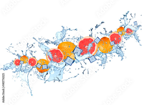 Fototapeta Water splash with grapefruits isolated on white background. Splash motion with fruits. Abstract object 