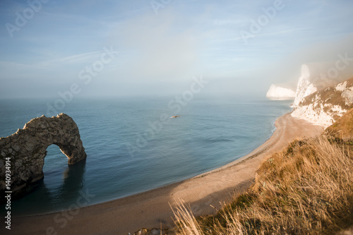 Poster Durdle Door is a natural limestone arch on the Jurassic Coast near Lulworth in D