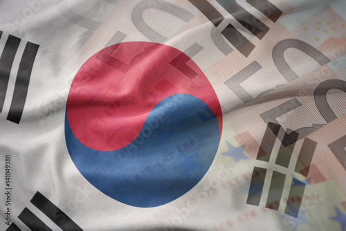 Poster colorful waving national flag of south korea on a euro money banknotes background