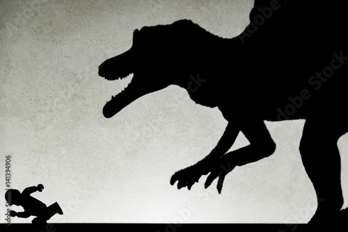 Poster shadow of spinosaurus chasing human on wall no logo or trademark