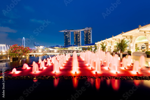 Poster Marina Bay Sands and a colorful fountain at night in Singapore.