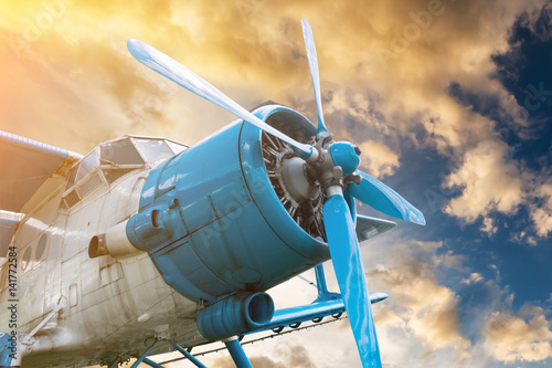plane with propeller on beautiful bright sunset sky background