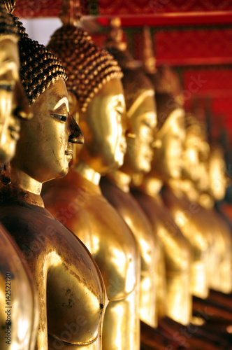 Poster Thailand, Bangkok - selective focus point on Buddha statue in Wat Arun temple of