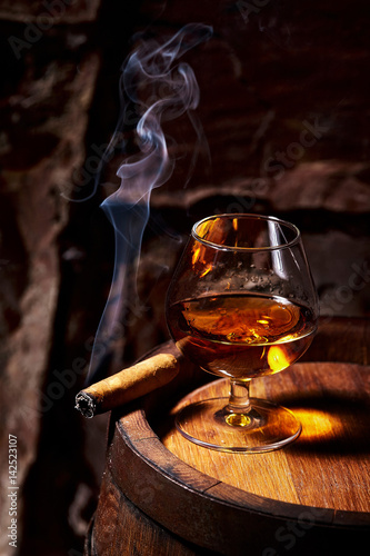 Cognac and Cigar on old oak barrel.