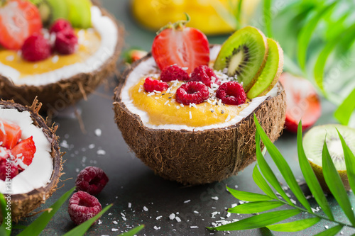 delicious mango  smoothie with fresh fruits and berries served in  coconut
