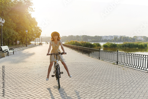 Young woman against nature background with bike