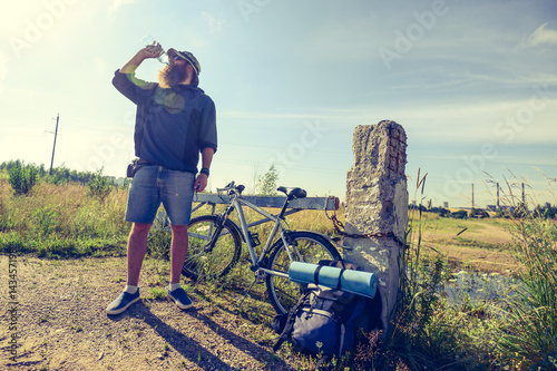 man drinks water on a halt