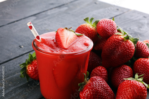 Fresh strawberry smoothie on wooden table