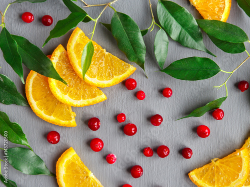 Fruit background design of citrus slices and cranberries. Fruit pattern.