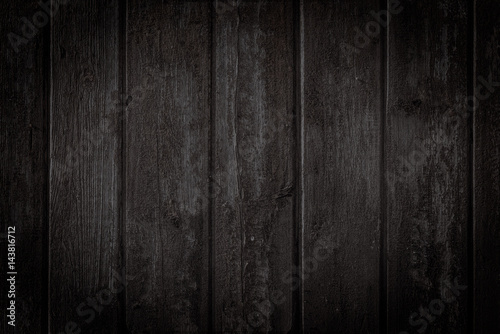 Fototapeta Old rural wooden wall in dark brown and black colors, detailed plank photo texture. Natural wooden building structure background.