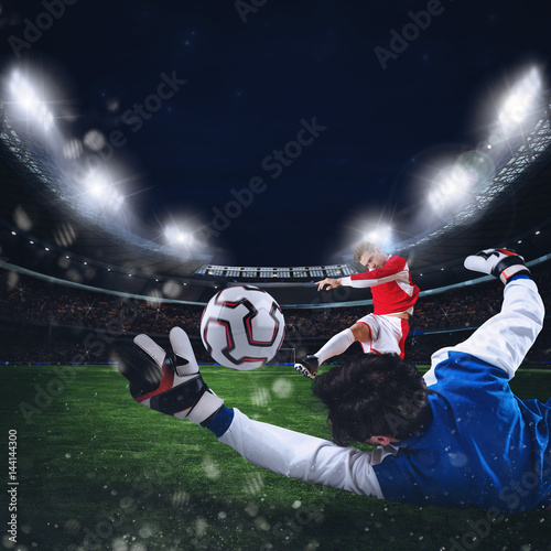 Fototapeta Goalkeeper catches the ball in the stadium