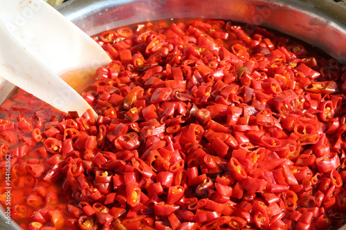 Poster red peppers typical of the Mediterranean countries with a white