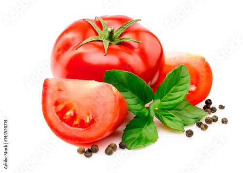 Tomatoes, basil leaves and black pepper on white.